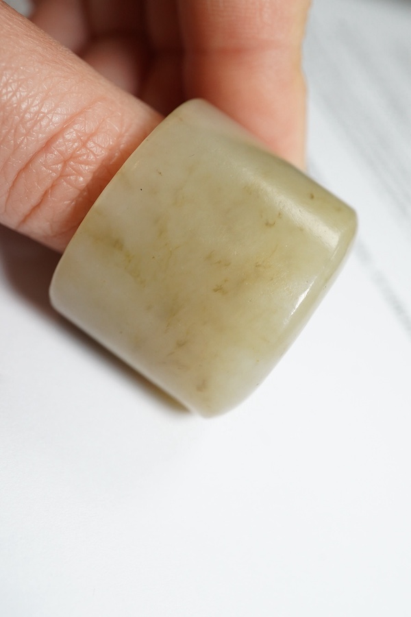 A Chinese pale celadon jade archer's thumb ring, 18th/19th century